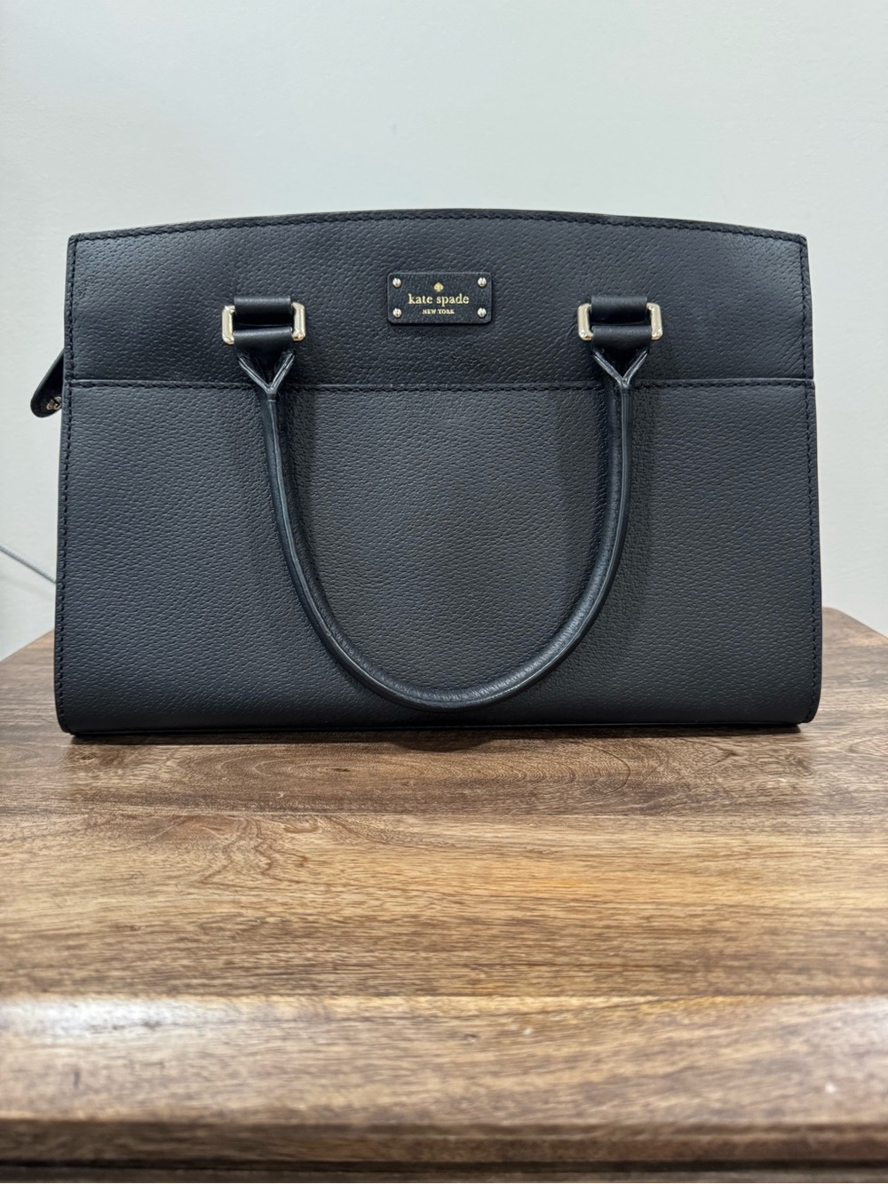 kate spade black pebbled leather satchel with gold-tone plaque